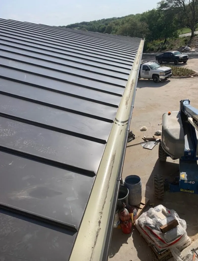 Standing seam panel and gutter detail on a metal roofing jobsite in Doctor Phillips
